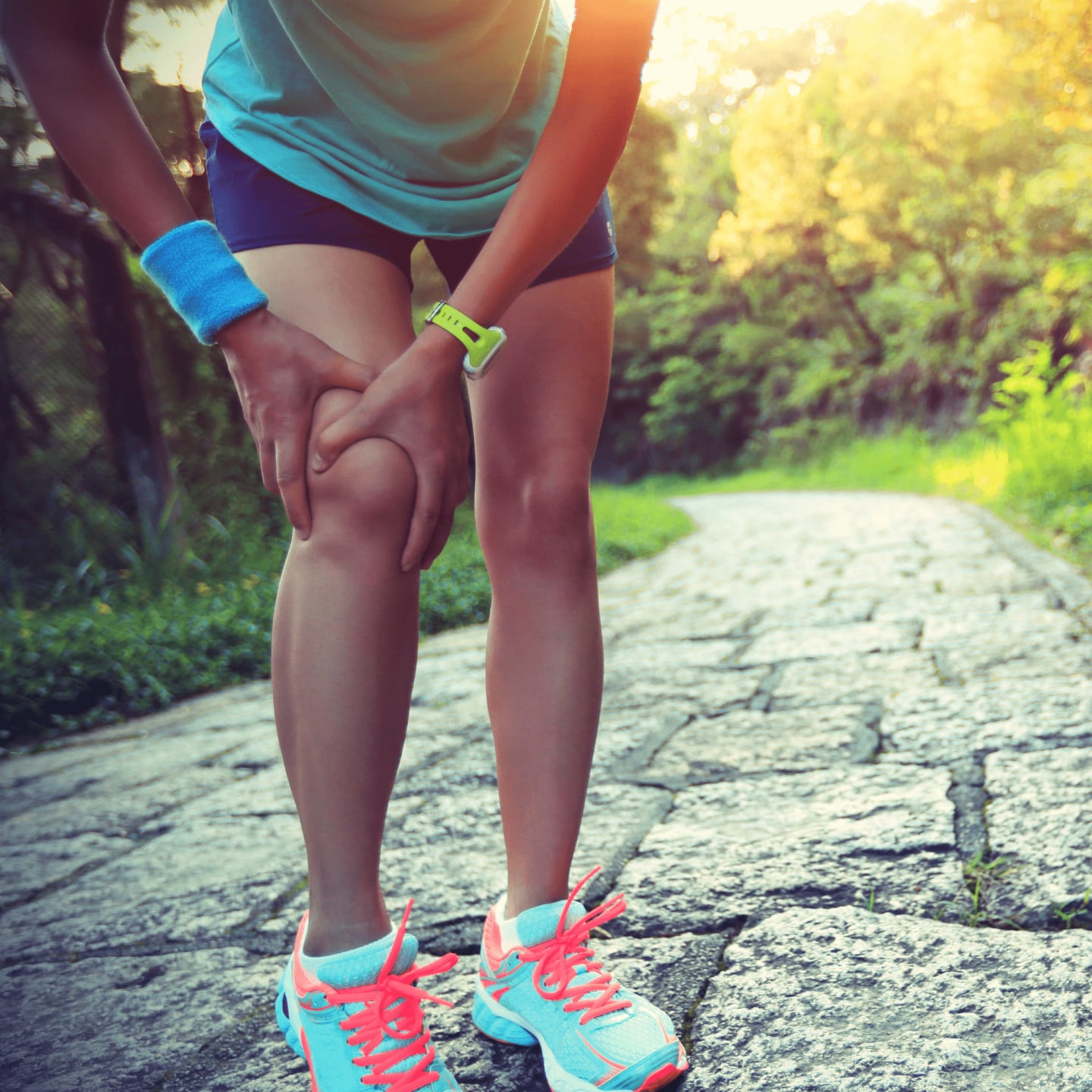 female runner holding knee in pain
