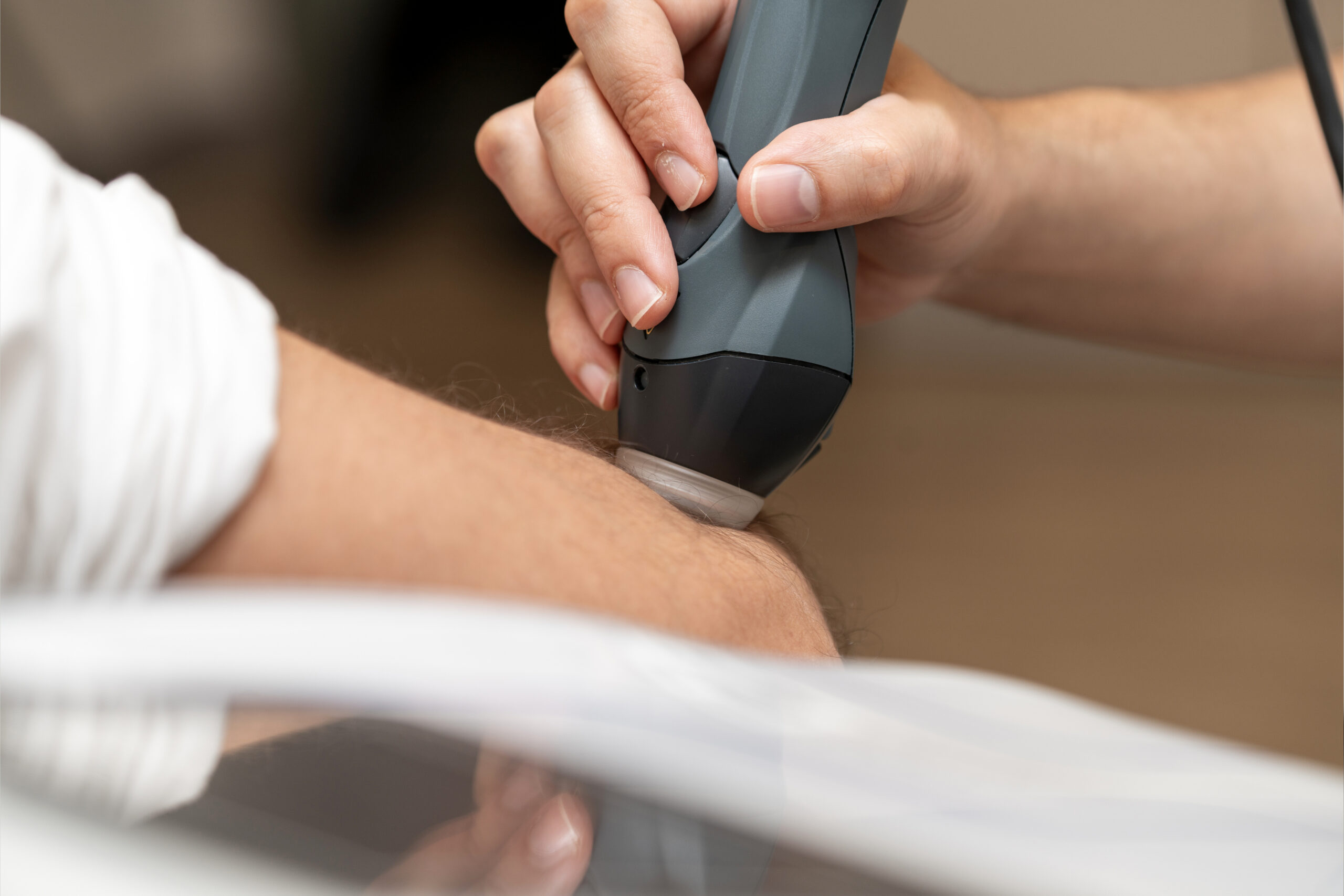 Physiotherapist using advanced MLS laser therapy handpiece for patient rehabilitation, non invasive musculoskeletal pain relief treatment, professional medical healthcare technology in modern clinic.