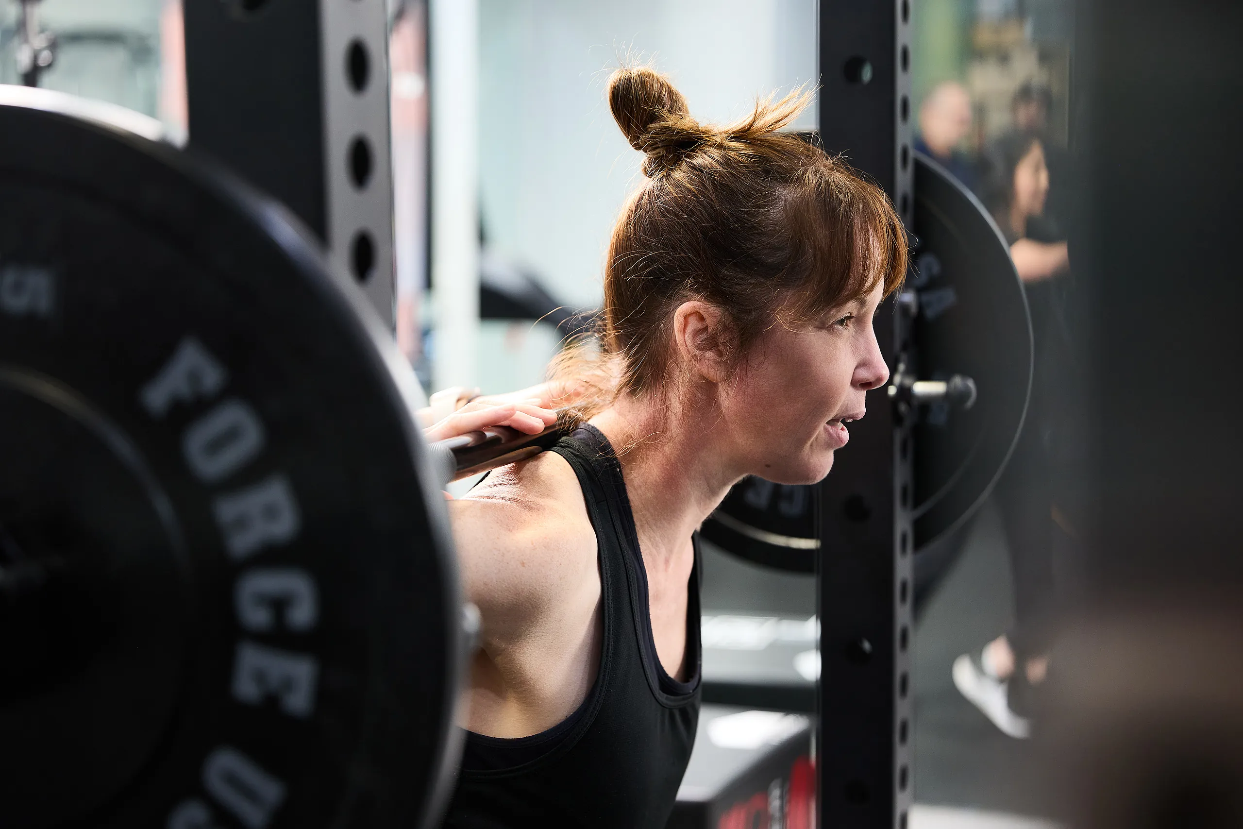 Pure Physio physiotherapist Janelle Tam guides a client through rehabilitation exercises in the gym at Queen Street clinic.
